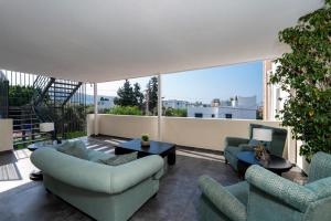 a living room with two couches and a balcony at Porto Sol Hotel Bodrum in Bodrum City +63 photos