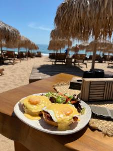 a plate of food on a table at the beach at Seafront Apartment with Panoramic Terrace in Golden Sands