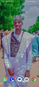 a man is dressed up in a whiteoine at Aromat villa in Kano