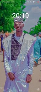 a man is dressed in at Aromat villa in Kano