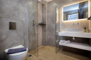 a bathroom with a shower and a toilet and a sink at Sea U in Kalívia