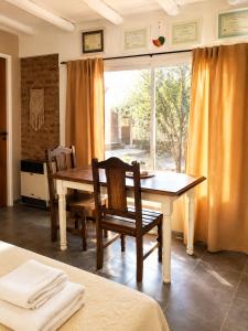 a dining room with a table and chairs and a window at Armonía y plenitud in Trelew +7 photos