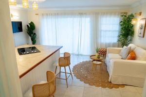 a kitchen and living room with a couch and a table at Golden View Unit 204 in Saint James