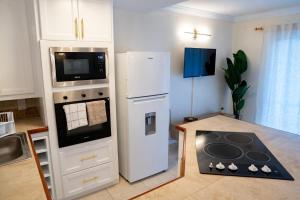 a kitchen with a white refrigerator and a microwave at Golden View Unit 204 in Saint James