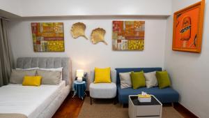 a living room with a couch and a chair at The Mosaic Tower Luxury Boutique Studio,Pool and Gym Fast Wifi in Manila +14 photos