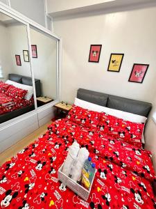 a bedroom with a bed with a red blanket and a mirror at Hope residences 501 building b in Trece Martires +3 photos