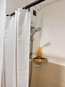 a shower curtain in a bathroom next to a shower at Hope residences 501 building b in Trece Martires