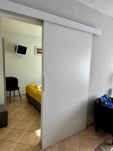 a room with a bed and a sliding glass door at Pensjonat Krystyna in Rewa