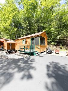 a cabin in the woods with a picnic table in front of it at Northern Acres in Lake George