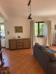 a living room with a couch and some windows at Landhaus mit Garten in Szczecin