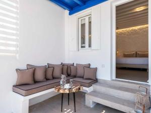 a living room with a couch and a table at Plateia House Mykonos in Mikonos