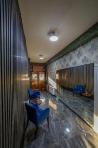 a lobby with two blue chairs and a table at Astro Suites in Istanbul