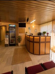 a lobby with a refrigerator and a bar in a room at Hotel Olimpiya in Balchik
