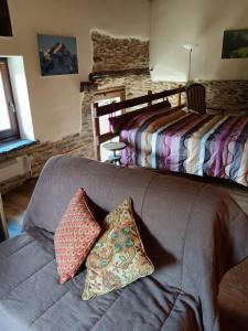 a living room with two beds and a couch with pillows at Casa delle Rose - Marmora in Marmora