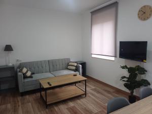 a living room with a couch and a table at Estafeta Apartament in Ponferrada