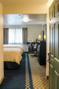 a hotel room with a bed and a desk at Fidalgo Country Inn in Anacortes +162 photos
