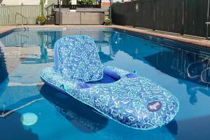 a blue chair sitting in a swimming pool at Fidalgo Country Inn in Anacortes