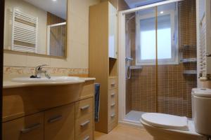 a bathroom with a toilet and a sink and a shower at Apartament Esmolet in La Pobla de Segur
