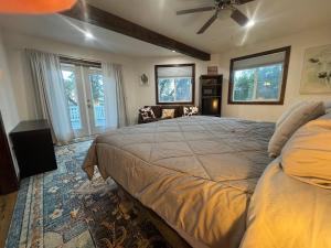 a bedroom with a large bed and two windows at Lakeview 4BR Huge Deck Dog Friendly ADA in Lakeside