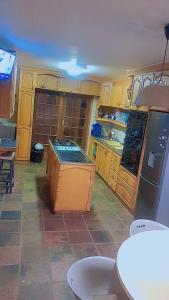 a kitchen with wooden cabinets and an island in it at Foodong Accommodation in Worcester