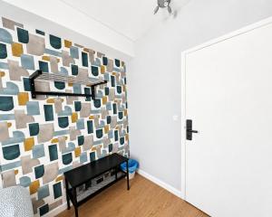 a room with a wall covered in colorful tiles at Porto Automatic in Porto