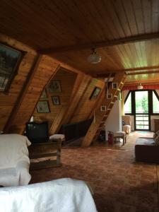 a attic room with a bed and a staircase at Willa Pod Brzozami in Korbielów