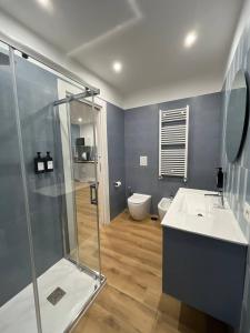 a bathroom with a shower and a sink and a toilet at The Family Rooms, Rione alto, Zona ospedaliera in Naples