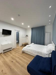 a bedroom with a bed and a tv on the wall at The Family Rooms, Rione alto, Zona ospedaliera in Naples