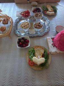 a table topped with plates of food on a table at Dada guest house in Bukhara