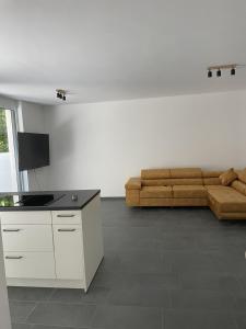 a living room with a couch and a table at M&S Apartments - Self Checkin in Degerfelden