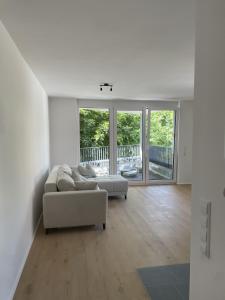 a living room with a couch and a table at M&S Apartments - Self Checkin in Degerfelden