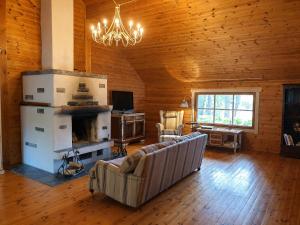 a living room with a couch and a fireplace at Saunatie in Taipalsaari