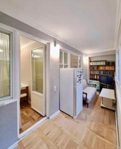 a living room with a white refrigerator in a room at Tumo cozy corner in Yerevan +7 photos