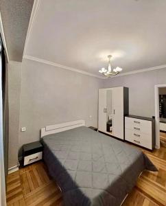 a bedroom with a large bed and a dresser at Tumo cozy corner in Yerevan