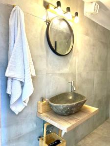 a bathroom with a stone sink and a mirror at Salty Rock - Kythnos Suite in Kithnos +21 photos