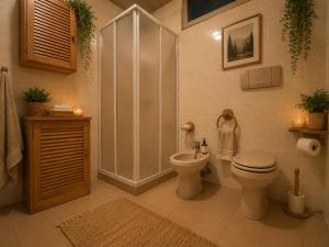 a bathroom with a shower and a toilet and a sink at Shared rooms BOC in Brunate +4 photos
