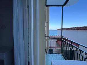 a room with a balcony with a view of the ocean at Metasuites Beach in Meta +23 photos