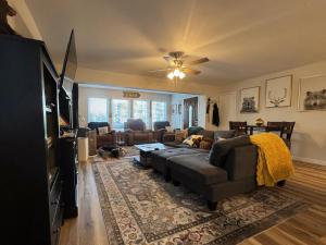 a living room with a couch and a tv at Lakeview 4BR Huge Deck Dog Friendly ADA in Lakeside