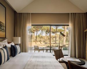 a bedroom with a large bed and a patio at Sublime Comporta in Comporta +175 photos