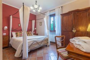 a bedroom with a canopy bed and a table at Ai due Cedri Appartamento Nocciolo in Capranica +40 photos