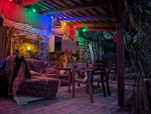 a patio with a table and chairs and lights at B59 guesthouse in Budakalász