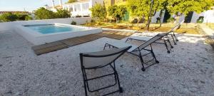 a group of chairs and a table next to a pool at Cantinho de Terena - Cheiros Da Terra in Terena