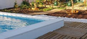 a swimming pool in a yard with a wooden deck at Cantinho de Terena - Cheiros Da Terra in Terena
