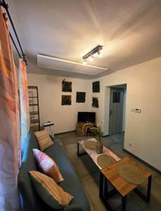 a living room with a couch and a table at Apartament Rosa in Rydułtowy