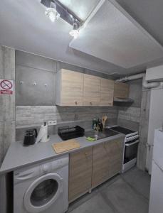 a kitchen with a washing machine and a washer at Apartament Rosa in Rydułtowy +8 photos