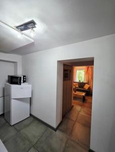 a room with a kitchen and a living room at Apartament Rosa in Rydułtowy