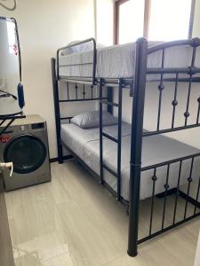 a bedroom with two bunk beds and a tv at Apartment in Chixchulub with a spectacular view in Chicxulub +20 photos