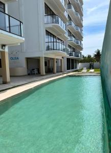a swimming pool in front of a building at Apartment in Chixchulub with a spectacular view in Chicxulub