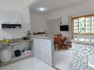 a kitchen with a sink and a counter top at Flat Alvorada in Ouro Preto