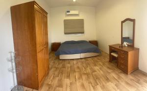 a bedroom with a bed and a dresser and a mirror at دور سياحي in Abha